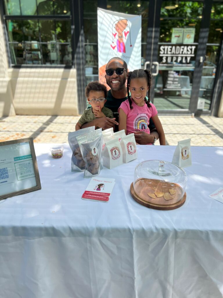 Elysia with her father Charles and baby brother at a local pop-up event.