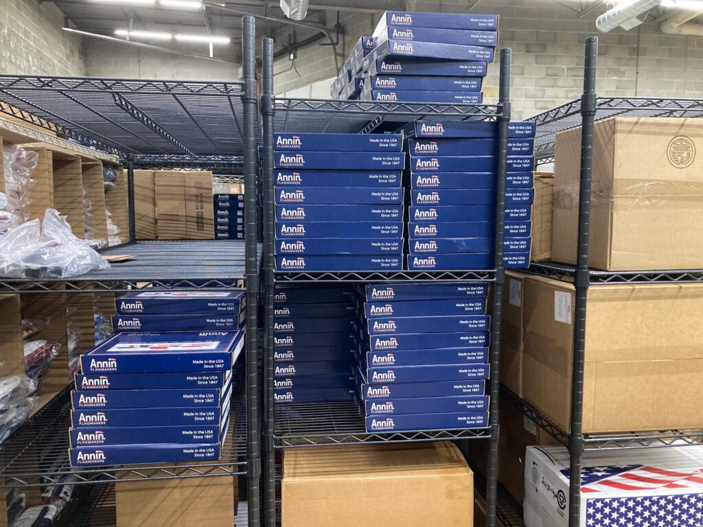 Shelves with boxes of various flags in the Flags USA warehouse