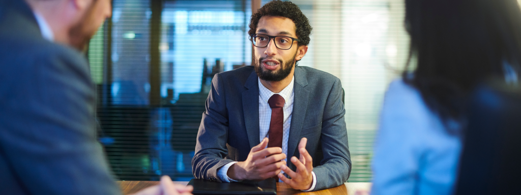 A man wearing a suit and tie at a job interview.